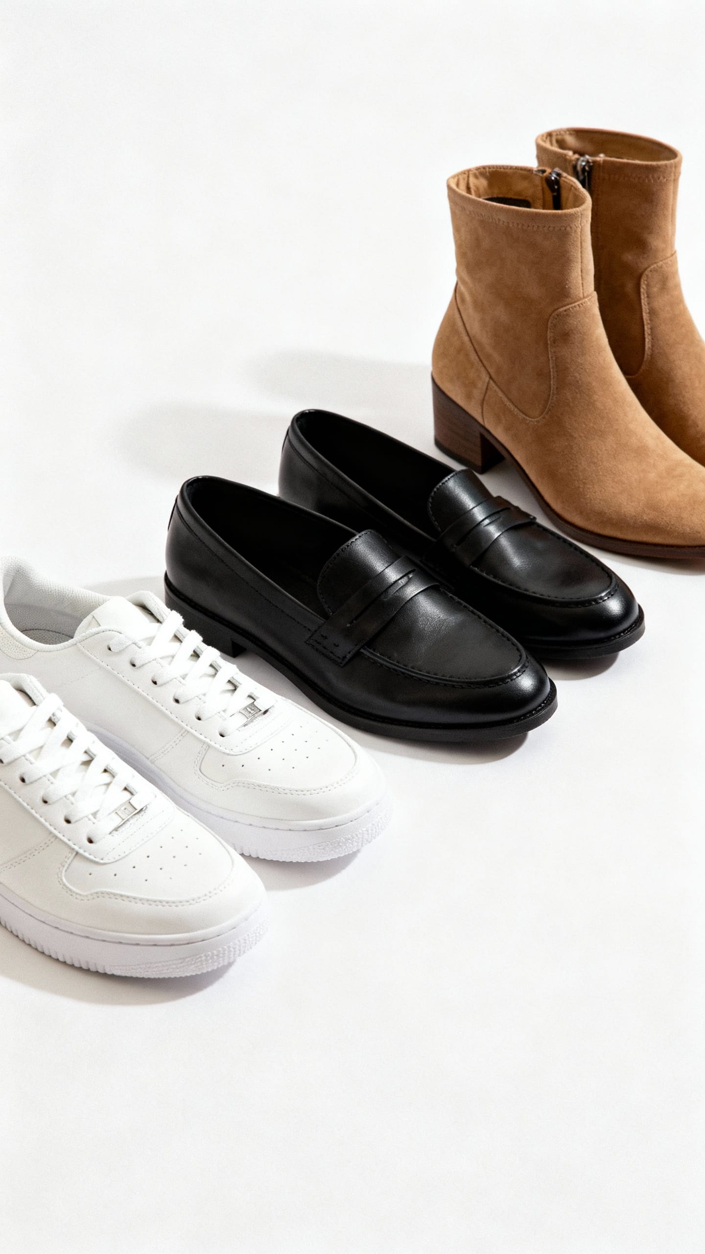 Shoe row at eye level, sleek white sneakers, black loafers, tan ankle boots, clean lighting