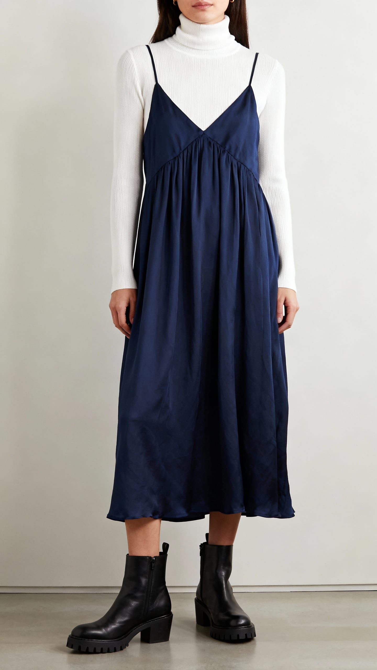 Navy slip dress layered with turtleneck and boots