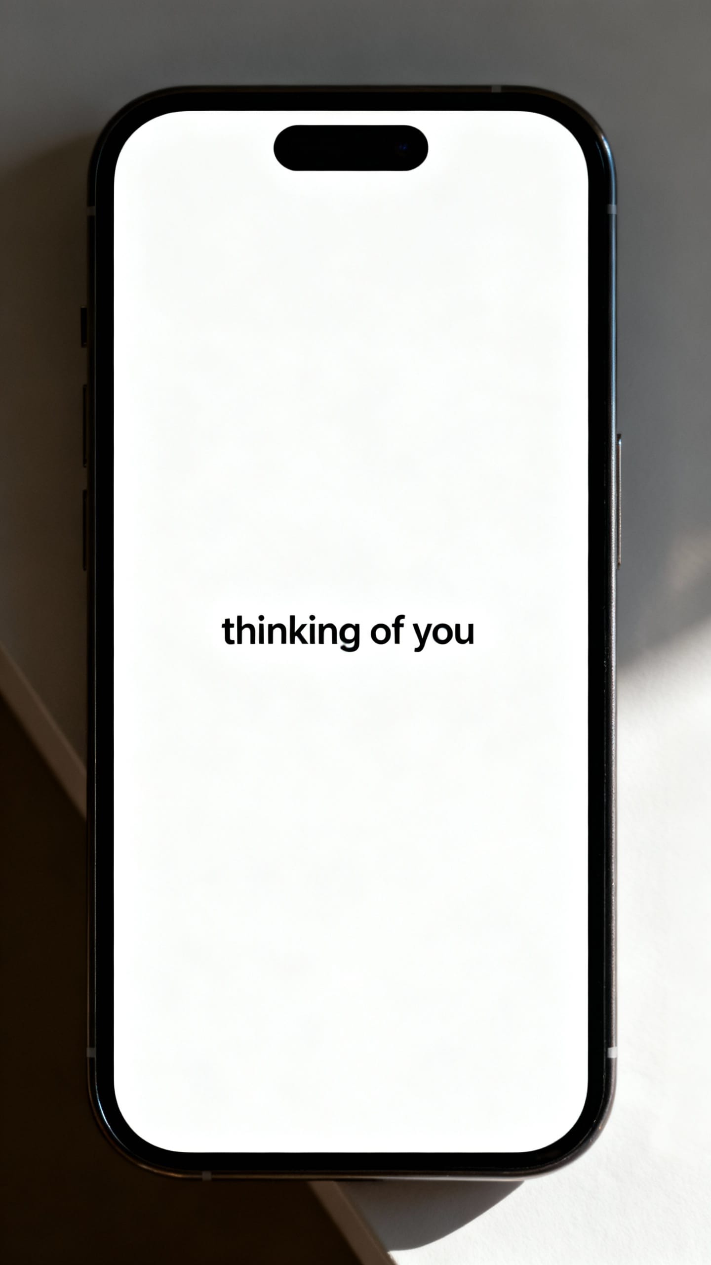 single text message “thinking of you” on clean phone screen